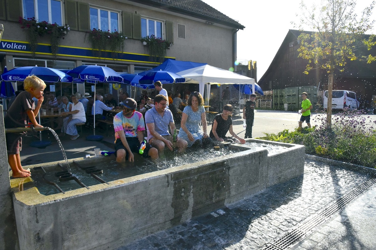 Eine Abkühlung im Dorfbrunnen mit Wasserspritzern gehörte auch für manchen Erwachsenen zum Strassenfest.